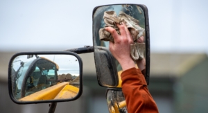 tractor mirror being cleaned 